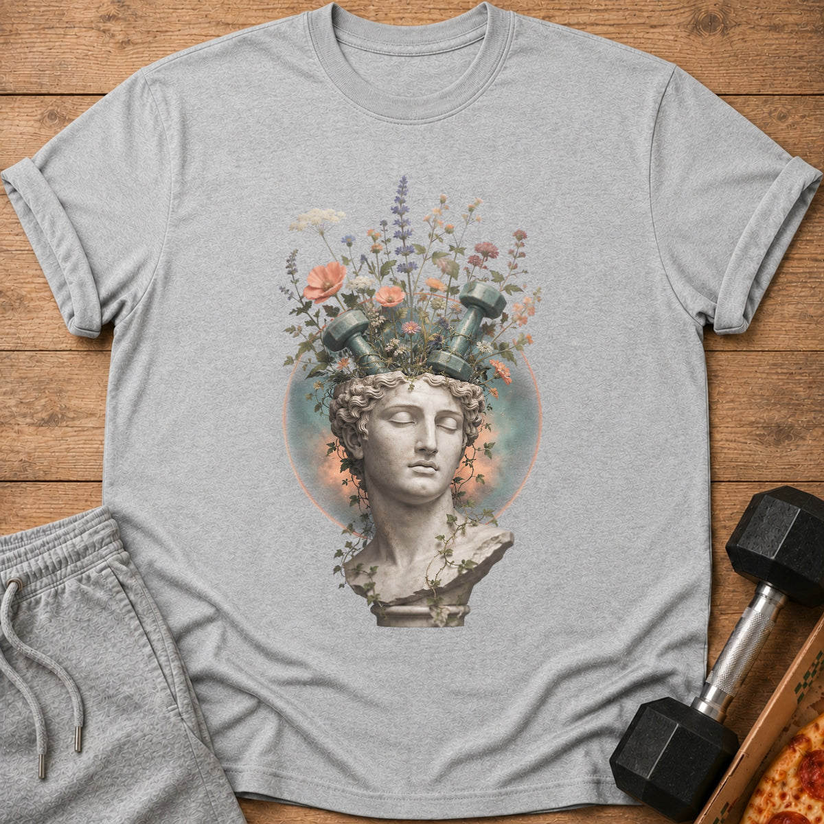 Grey t-shirt with a statue bust, flowers, and dumbbells on the front.
