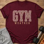 Maroon t-shirt with "GYM WEATHER" text in leopard print and tan lettering.
