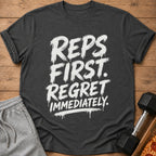 Dark grey t-shirt with white text "REPS FIRST. REGRET IMMEDIATELY."