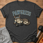 Cat with dumbbell and text "PAWGRESS" on a t-shirt.