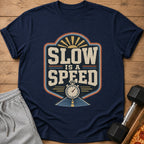 Navy t-shirt with "SLOW IS A SPEED" graphic, stopwatch, and sunburst.