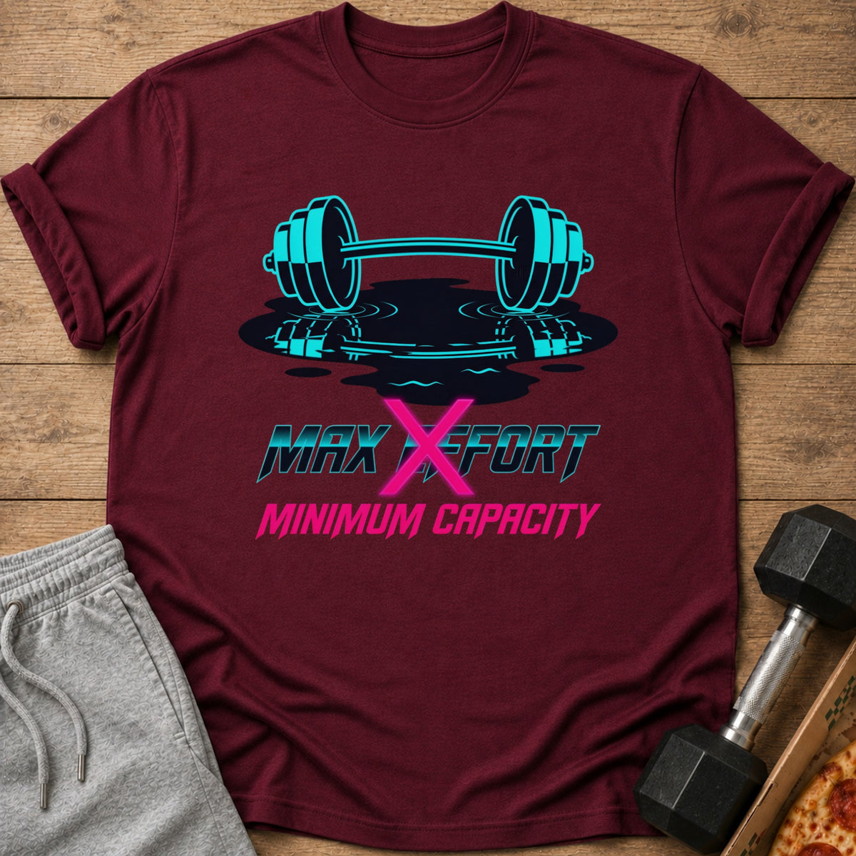 Maroon t-shirt with a neon blue barbell and text: MAX X EFFORT MINIMUM CAPACITY.