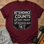 Maroon t-shirt with "Attendance Counts: Body Present, Motivation Absent" graphic.