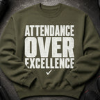 Olive green sweatshirt with "Attendance Over Excellence" text and a checkmark.