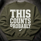 Olive green sweatshirt with distressed white text "THIS COUNTS PROBABLY" and a checkmark.