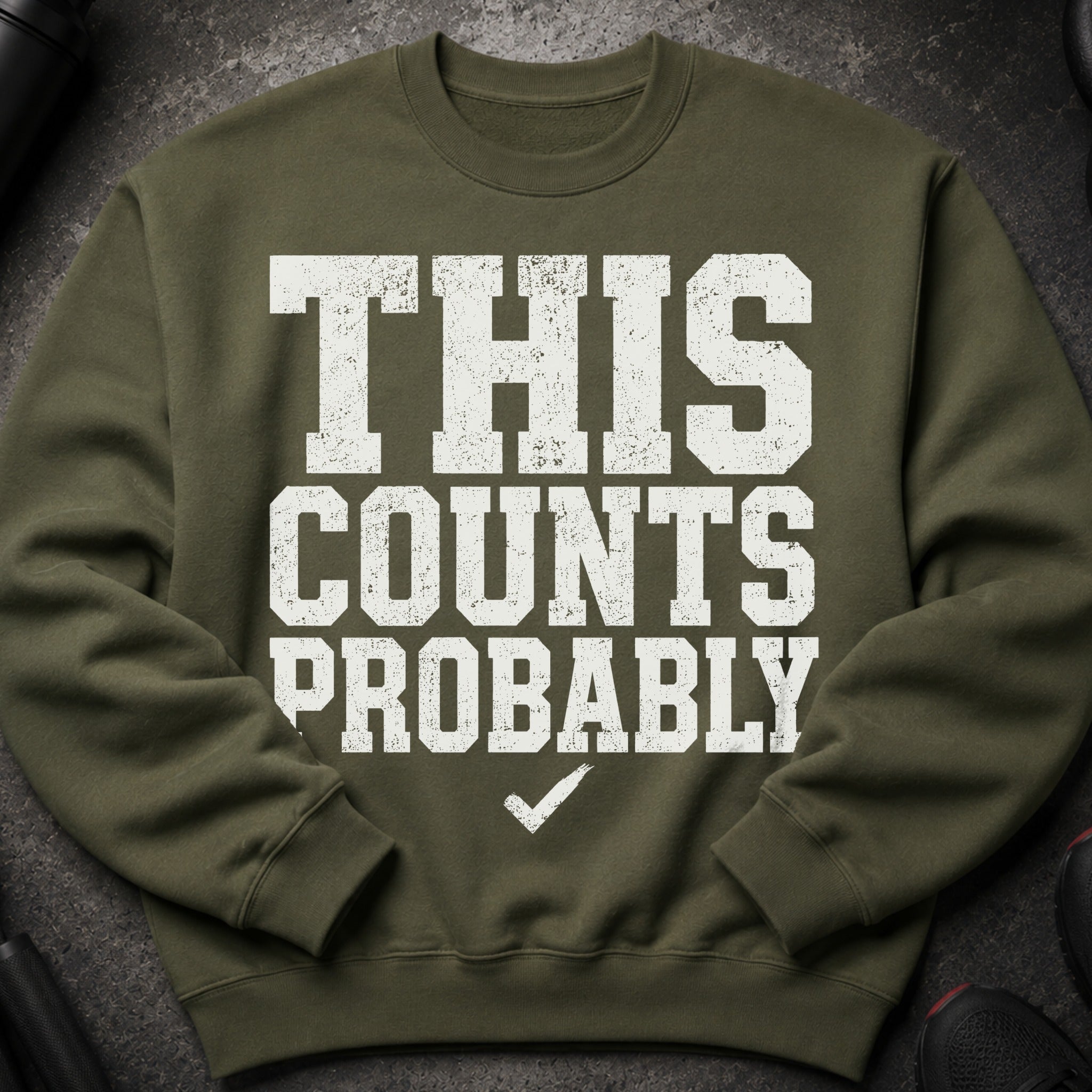 Olive green sweatshirt with distressed white text "THIS COUNTS PROBABLY" and a checkmark.