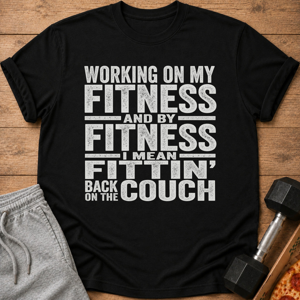 Black t-shirt with "Working on my fitness and by fitness I mean fittin' back on the couch" text.