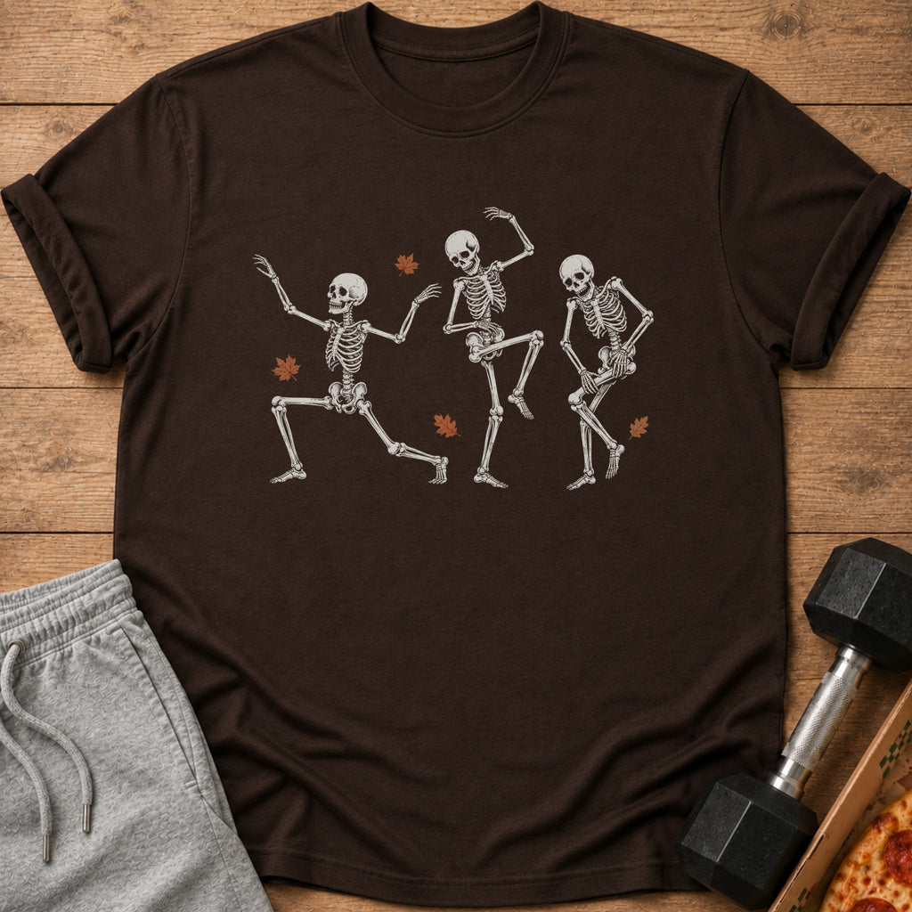 Brown t-shirt with three dancing skeletons and fall leaves graphic.