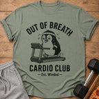 Green t-shirt with distressed penguin on treadmill graphic and "Out of Breath Cardio Club" text.