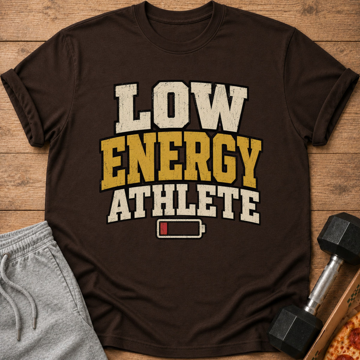Brown t-shirt with text "LOW ENERGY ATHLETE" and a low battery symbol.