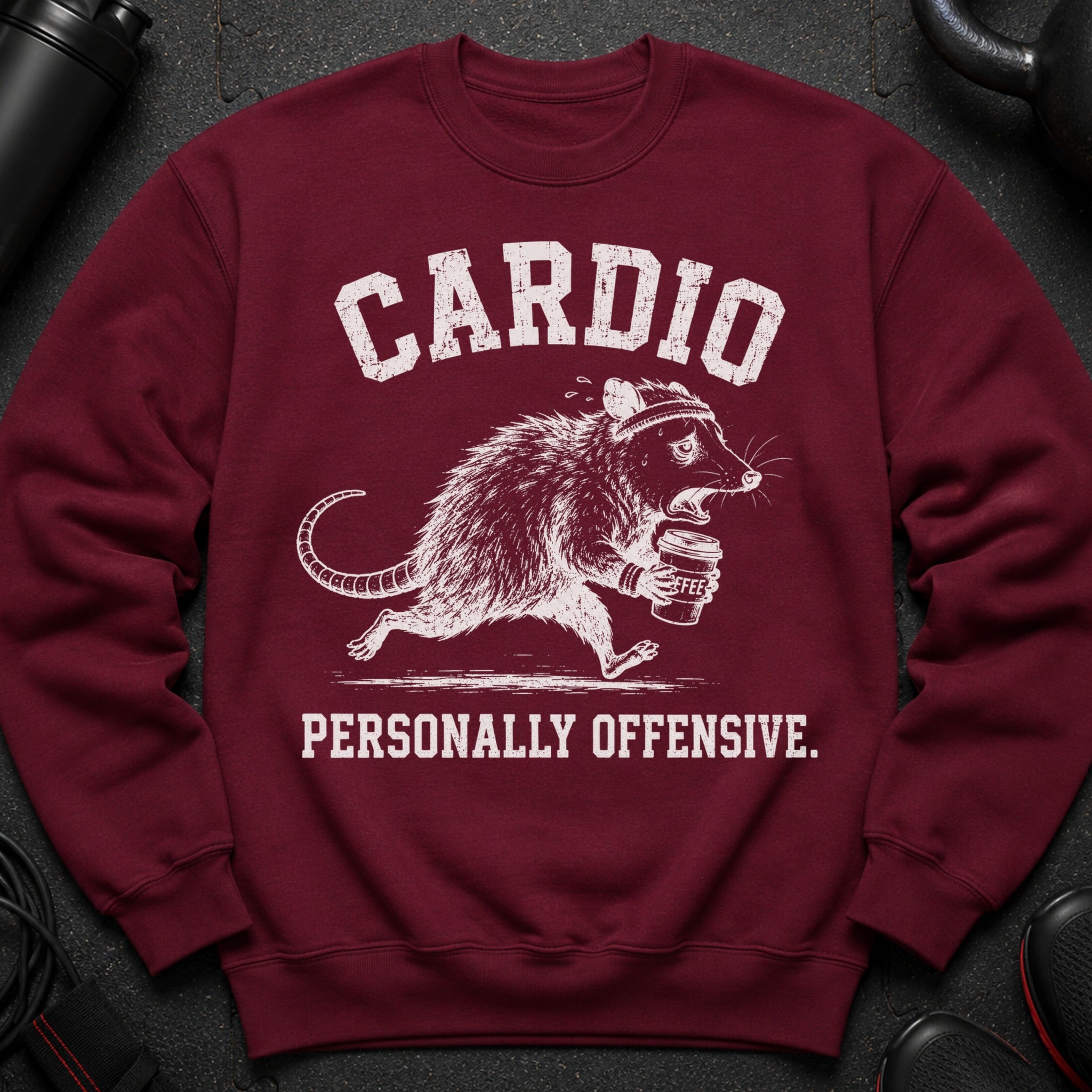 Maroon sweatshirt with distressed white text "CARDIO" and a running possum with coffee cup.
