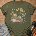 Green t-shirt with sloth on float, "GO WITH THE SLOW" text, and heart sunglasses.