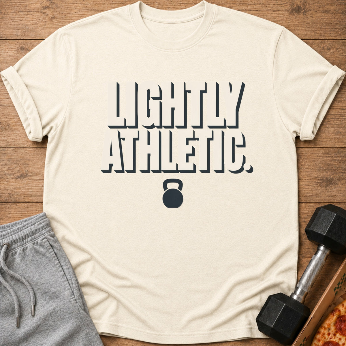 Cream t-shirt with "LIGHTLY ATHLETIC." text and kettlebell graphic.