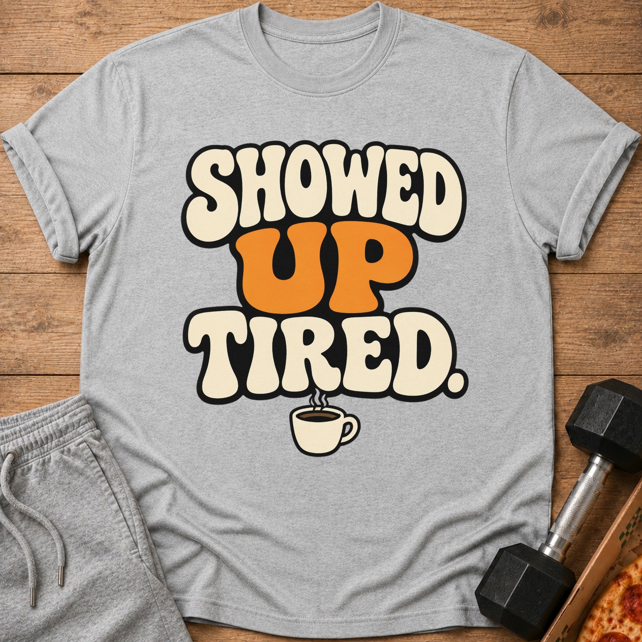 Grey t-shirt with "SHOWED UP TIRED" text and coffee cup graphic.