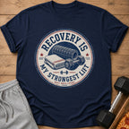 Navy t-shirt with circular graphic: "Recovery is my strongest lift. Rest reps count."