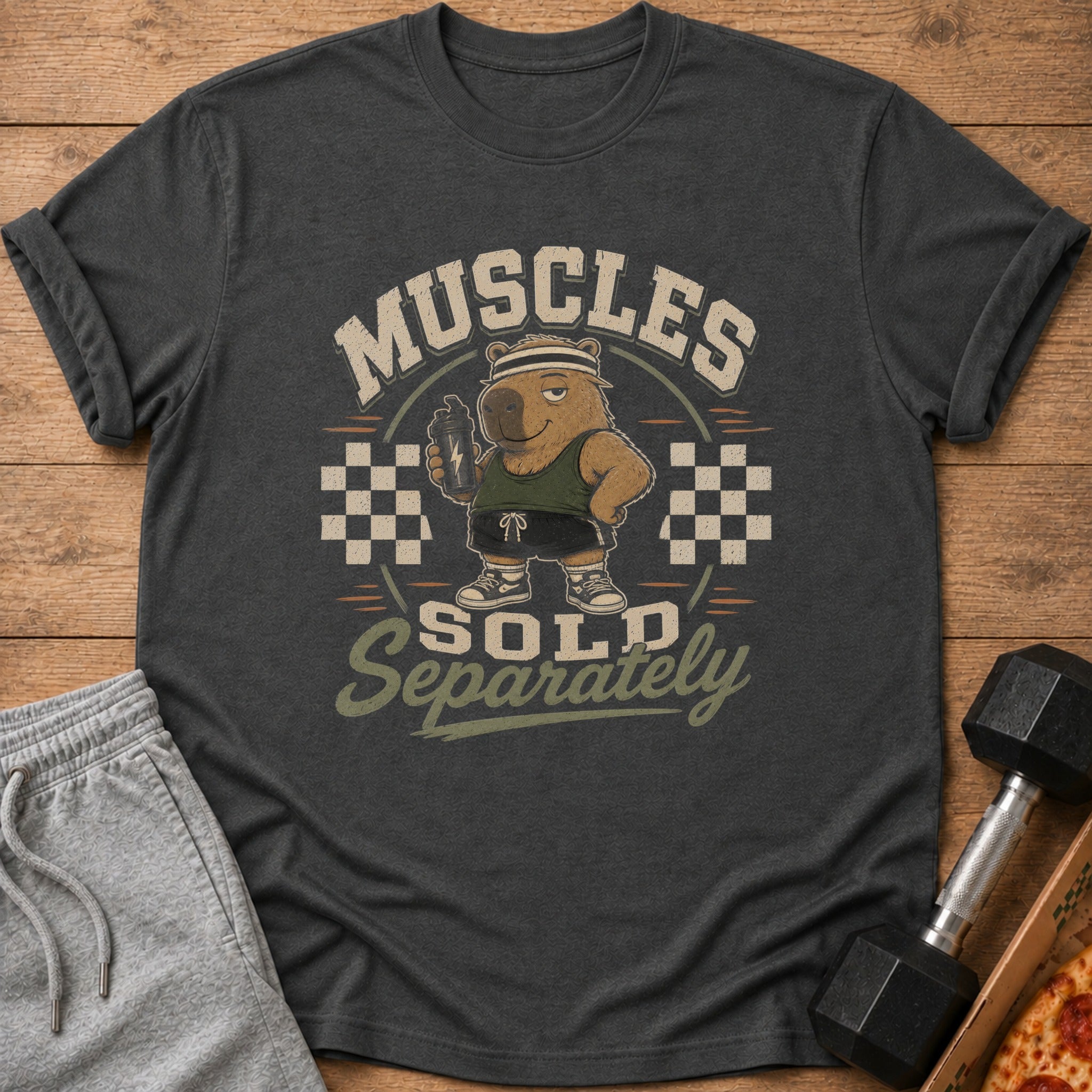 Dark grey t-shirt with a cartoon bear holding a shaker and the text "Muscles Sold Separately".