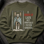 Green sweatshirt with a sloth hanging on a bar, text reads "I showed up late but spiritually I never arrived."
