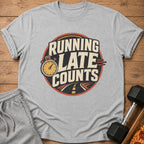 Grey t-shirt with "RUNNING LATE COUNTS" graphic and stopwatch.