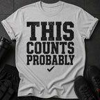 Grey t-shirt with distressed black text "THIS COUNTS PROBABLY" and a checkmark.