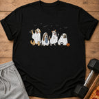 Four dogs in ghost costumes with Halloween-themed props on a black t-shirt.