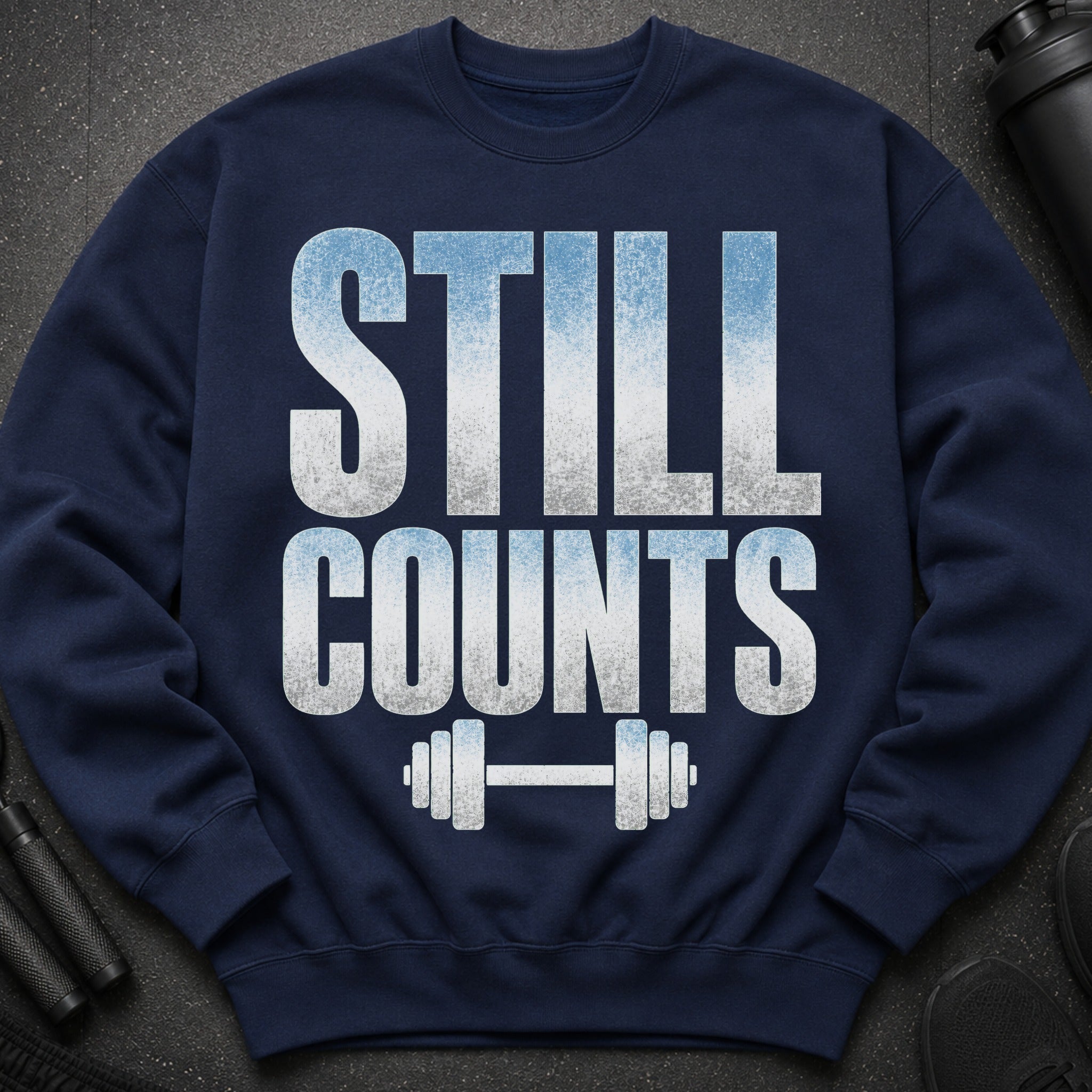 Navy sweatshirt with "STILL COUNTS" text and a dumbbell graphic.