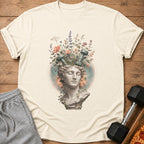 Bust of statue with dumbbells and flowers growing from head.