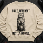 Lightweight cream sweatshirt with a cat holding a kettlebell graphic and text.