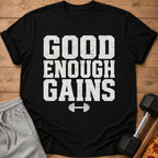 Black t-shirt with "GOOD ENOUGH GAINS" text and barbell graphic.