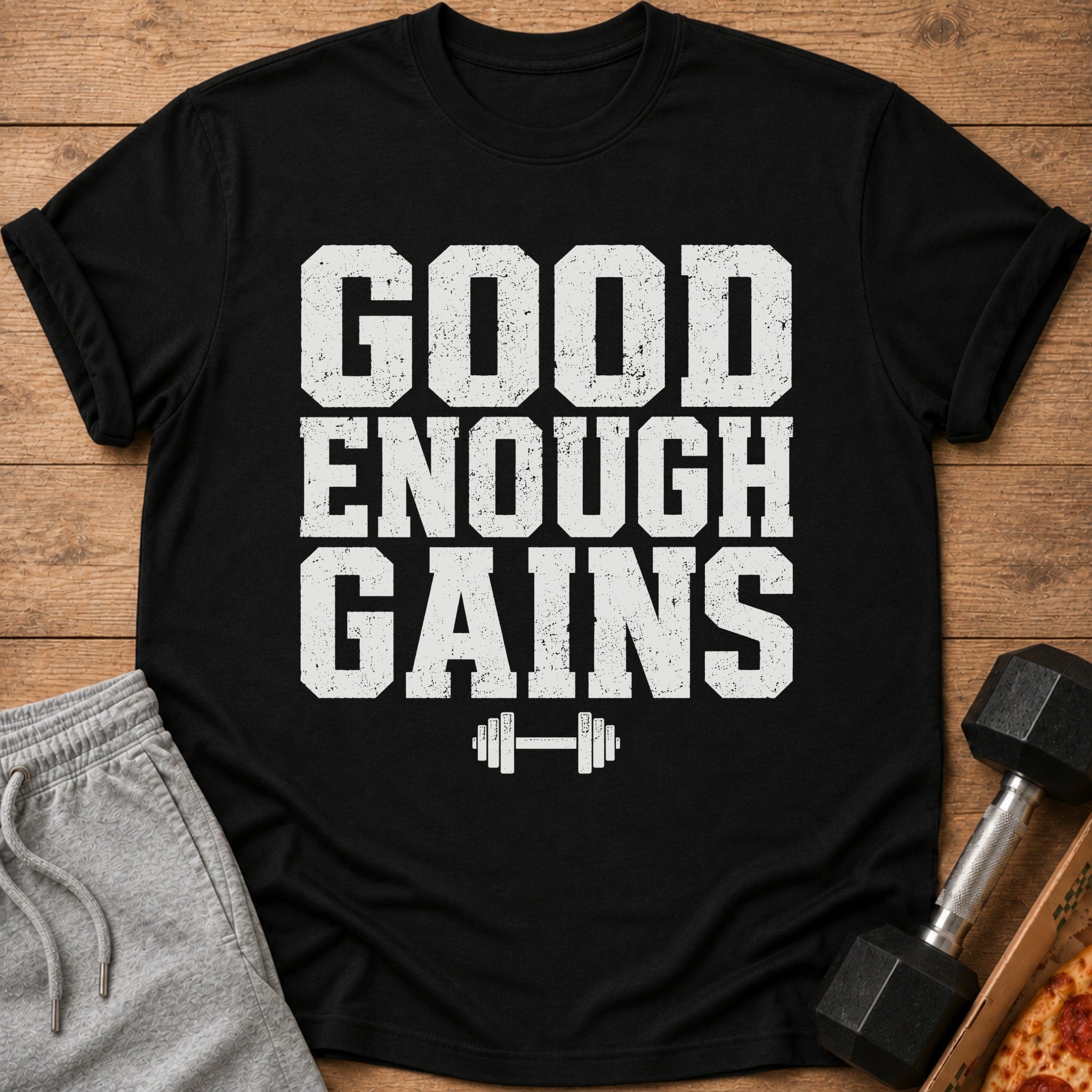 Black t-shirt with "GOOD ENOUGH GAINS" text and barbell graphic.