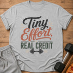 Grey t-shirt with "Tiny Effort, Real Credit" and a dumbbell graphic.