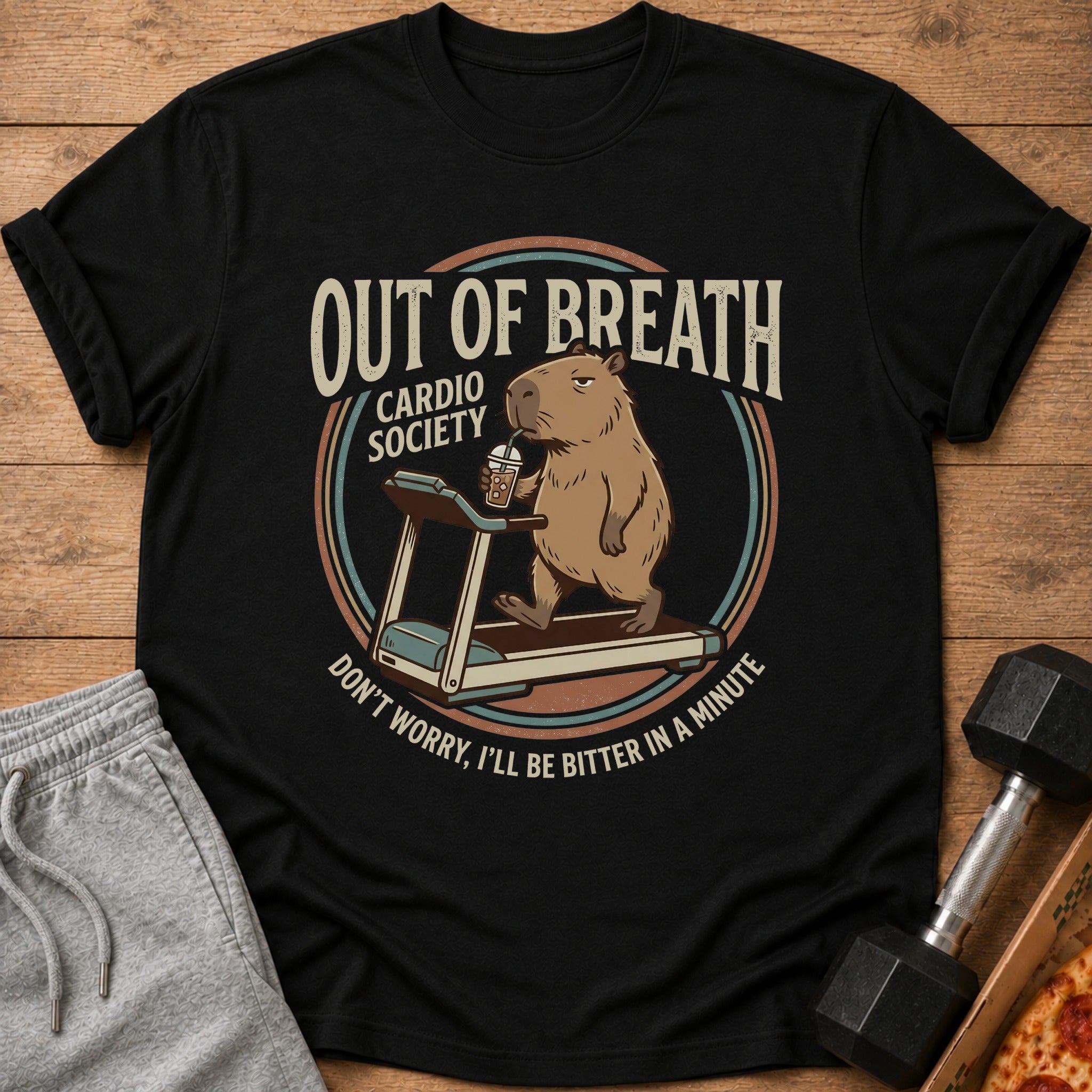 Black t-shirt with a capybara on a treadmill and the text "OUT OF BREATH CARDIO SOCIETY".