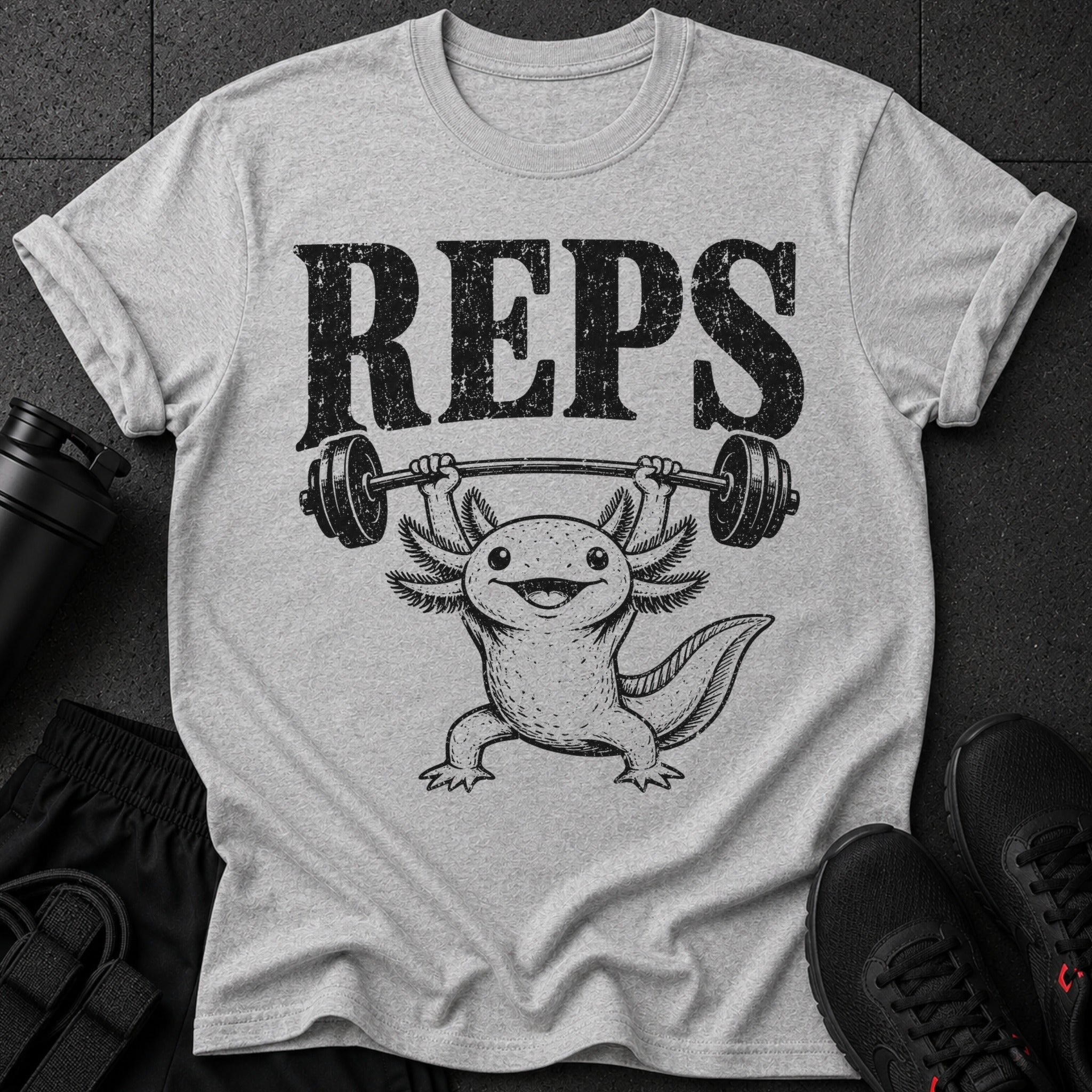 Grey t-shirt with black distressed text "REPS" and an axolotl lifting a barbell.