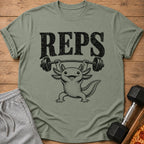 T-shirt with "REPS" text and a drawing of an axolotl lifting a barbell.