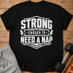Black t-shirt with text "STRONG ENOUGH TO NEED A NAP"