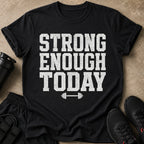 Black t-shirt with distressed white text "STRONG ENOUGH TODAY" and barbell graphic.