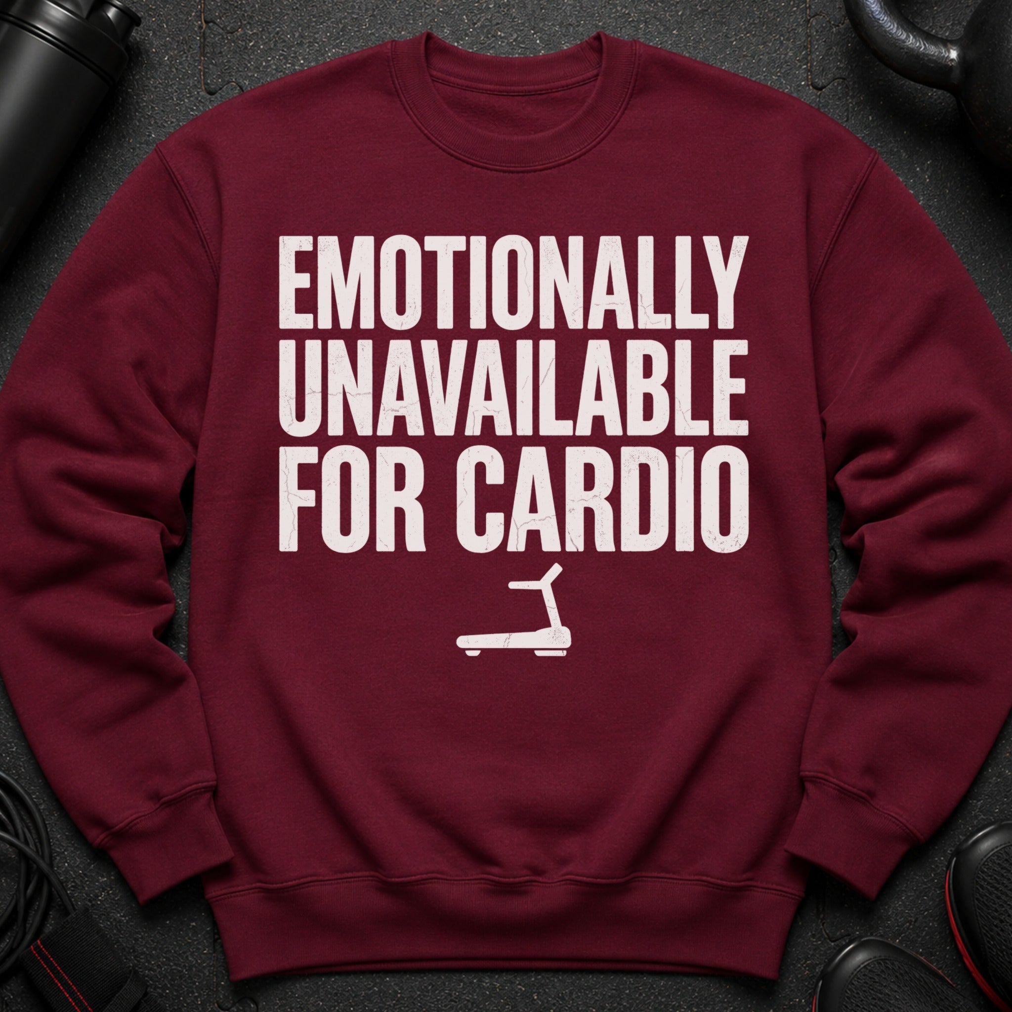 Maroon sweatshirt with white text "EMOTIONALLY UNAVAILABLE FOR CARDIO" and treadmill graphic.