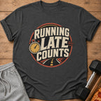 Dark t-shirt with "Running Late Counts" graphic, stopwatch, and road design.