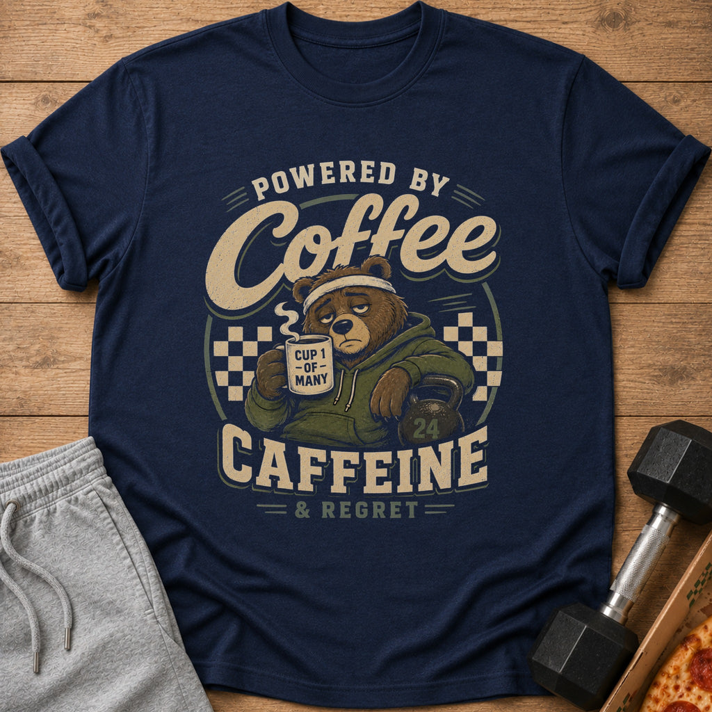 Navy t-shirt with a distressed graphic of a tired bear holding coffee and the text "Powered by Coffee, Caffeine & Regret."