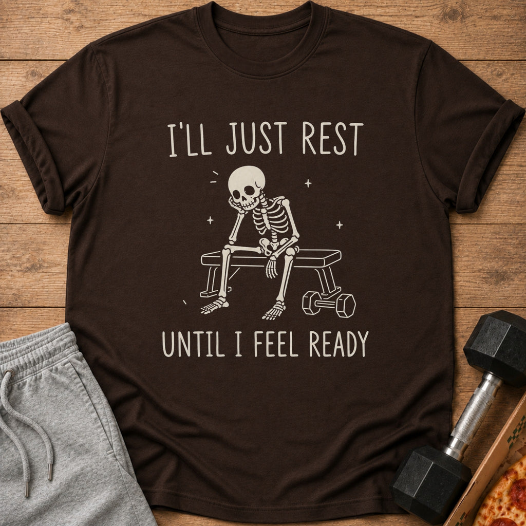 Brown t-shirt with a skeleton sitting on a bench with text: "I'LL JUST REST UNTIL I FEEL READY".