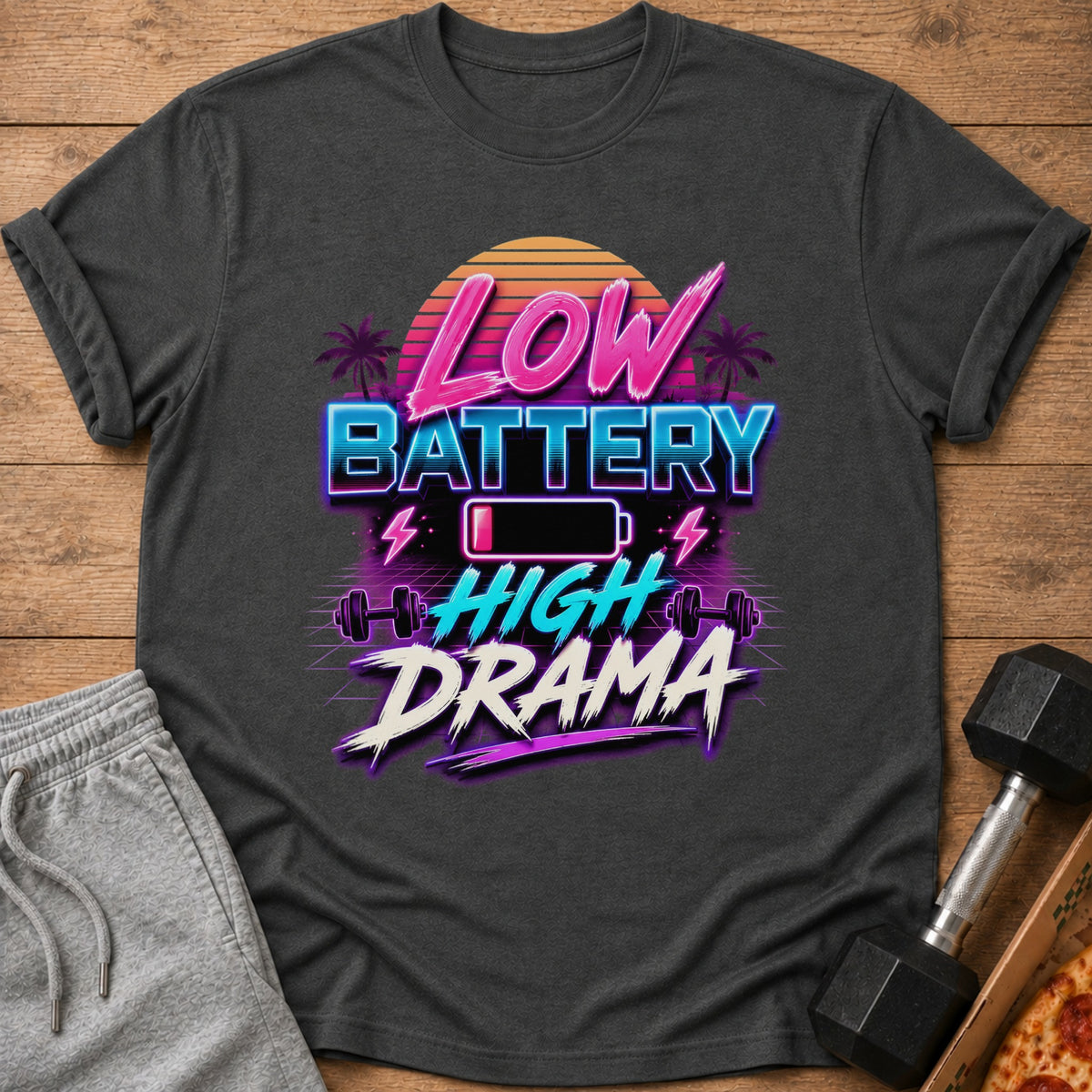 Dark gray t-shirt with neon text "Low Battery High Drama" and gym graphics.