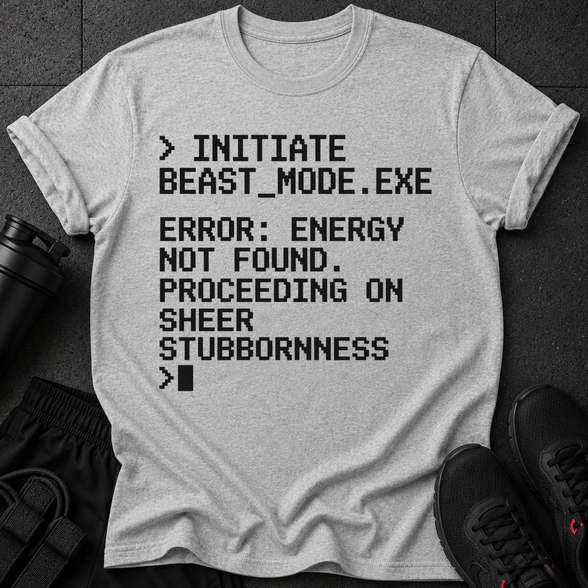 Grey t-shirt with black pixelated text: Initiate Beast Mode, Error Energy Not Found, Proceeding on Sheer Stubbornness.