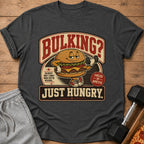T-shirt with cartoon burger lifting dumbbell and text "Bulking? Just Hungry."