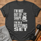 Dark gray t-shirt with distressed text: "I'M NOT OUT OF SHAPE, I'M IN A RESTING SET".