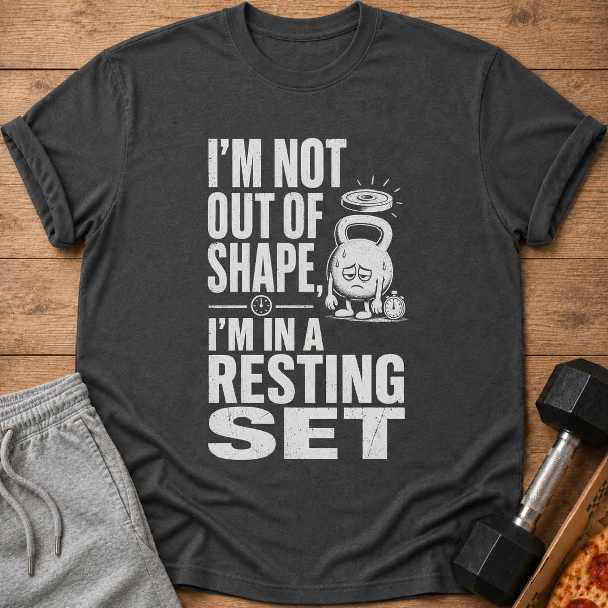 Dark gray t-shirt with distressed text: "I'M NOT OUT OF SHAPE, I'M IN A RESTING SET".