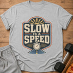 Grey t-shirt with "Slow is a Speed" graphic, stopwatch, and a road.