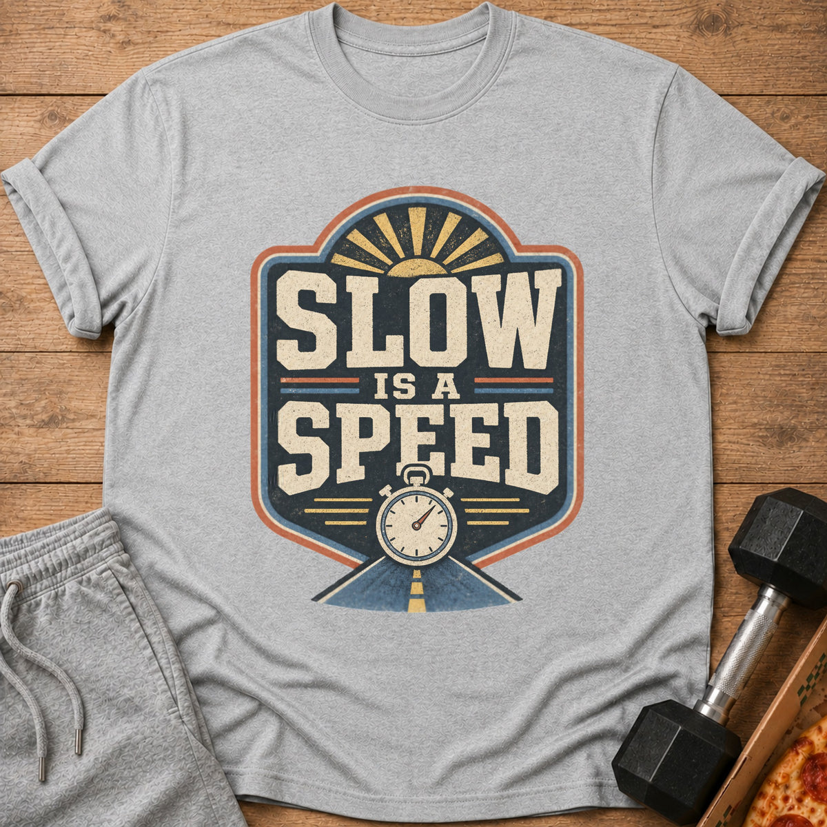 Grey t-shirt with "Slow is a Speed" graphic, stopwatch, and a road.