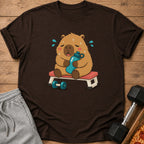 Brown t-shirt with a cartoon capybara holding a water bottle on a bench, sweating.