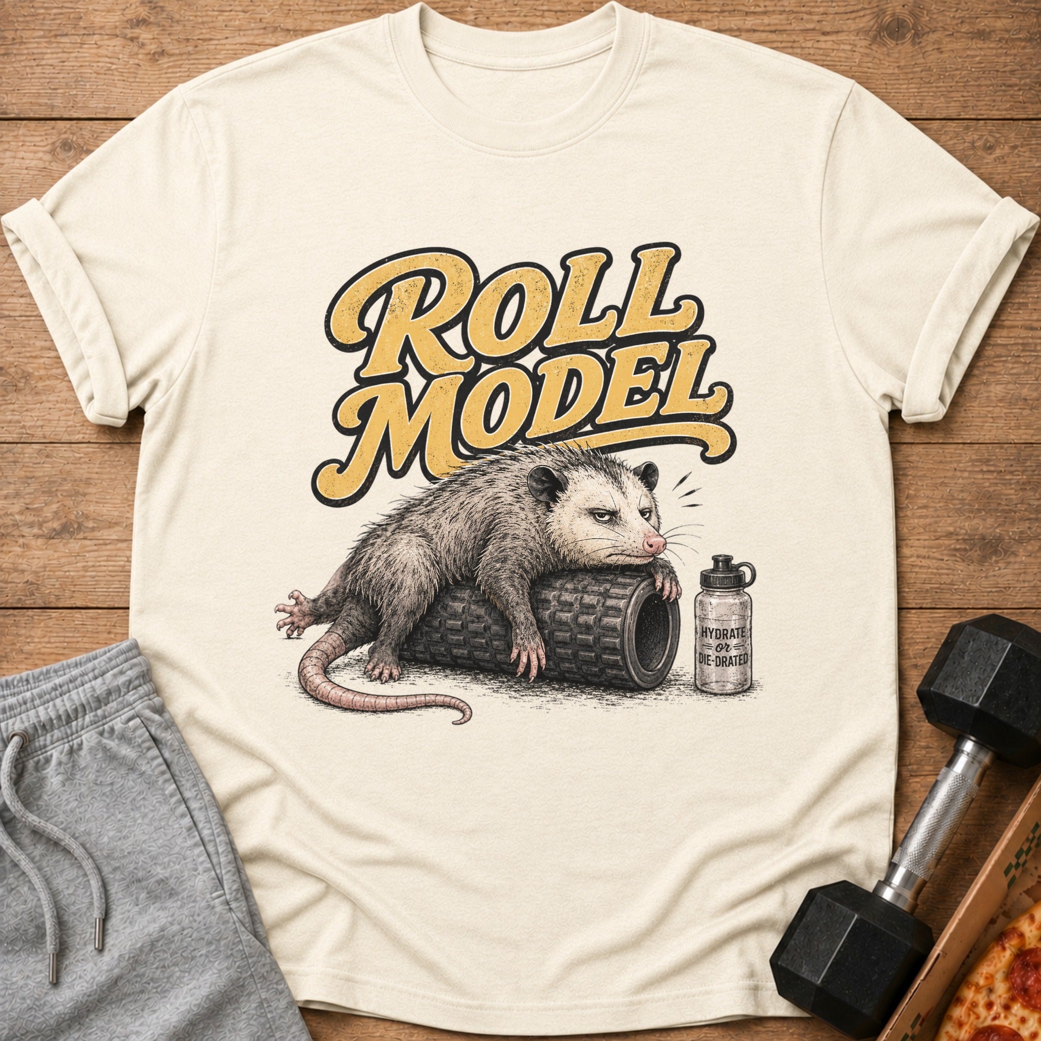T-shirt graphic of an opossum on a foam roller with text "Roll Model" and water bottle.