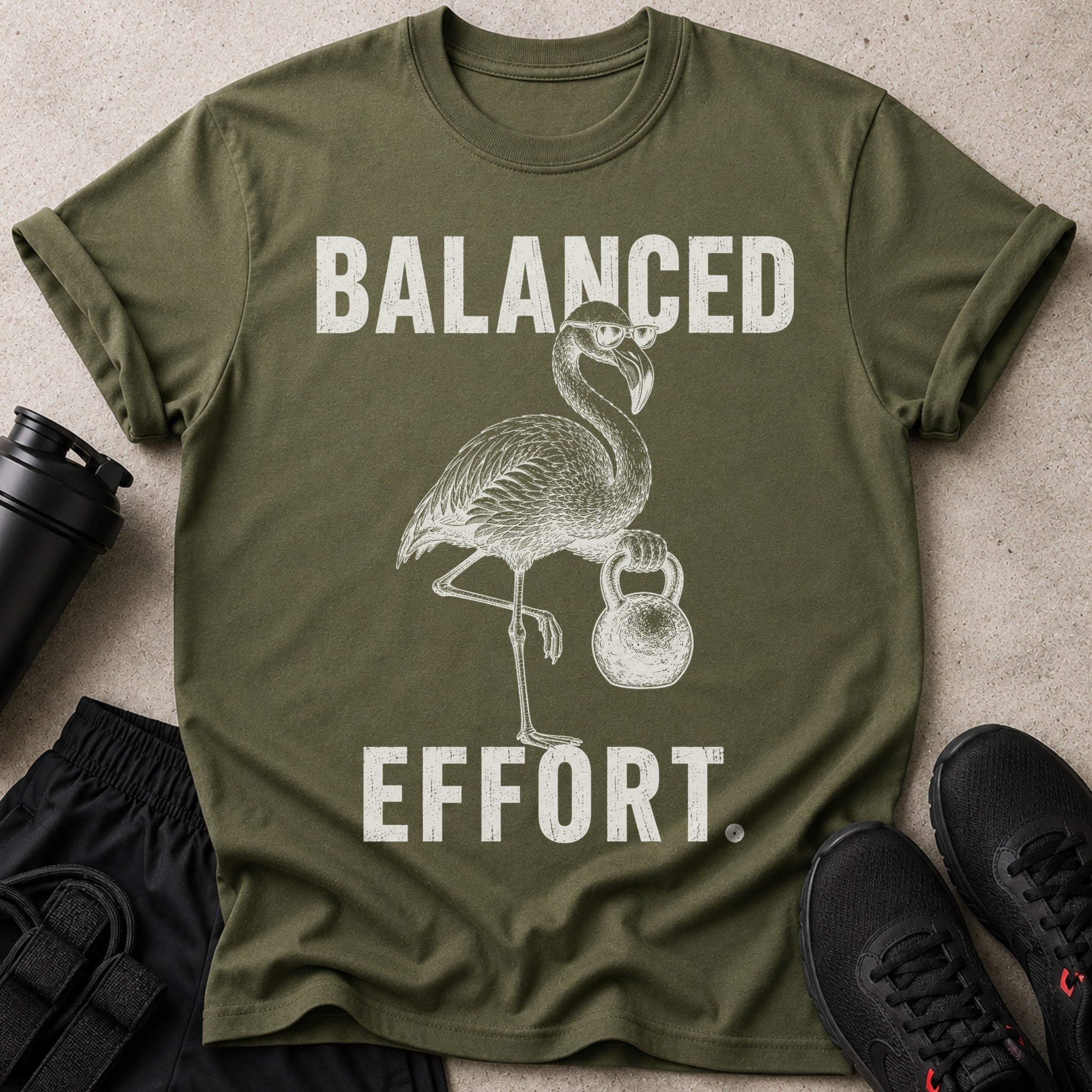 Olive green t-shirt with distressed white text and flamingo graphic.