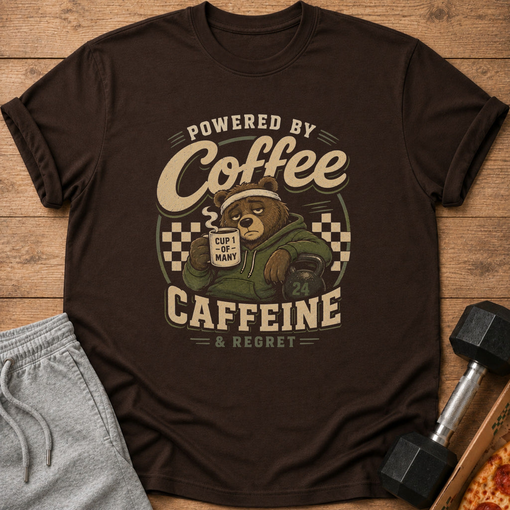 Brown t-shirt with graphic of a bear drinking coffee and the text "Powered by Coffee Caffeine & Regret".